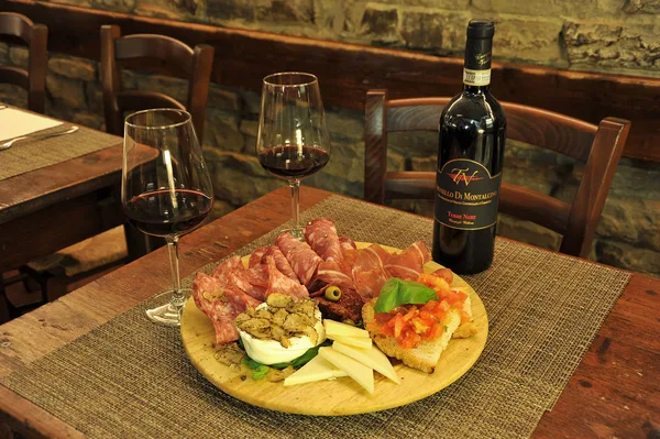 Cured meats, cheese and crostini with a red wine from Montalcino.